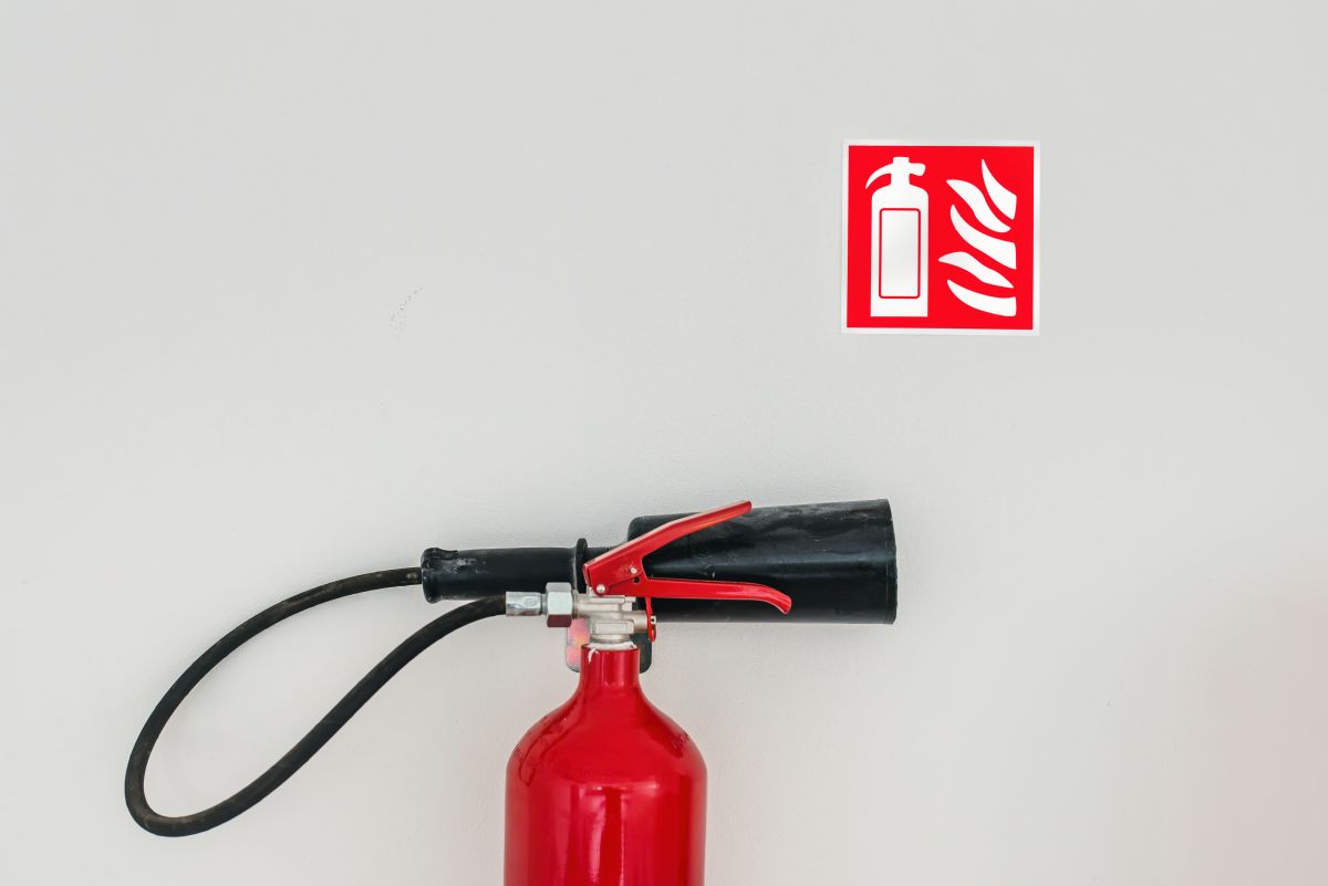 Fire extinguisher and safety sign mounted on a wall