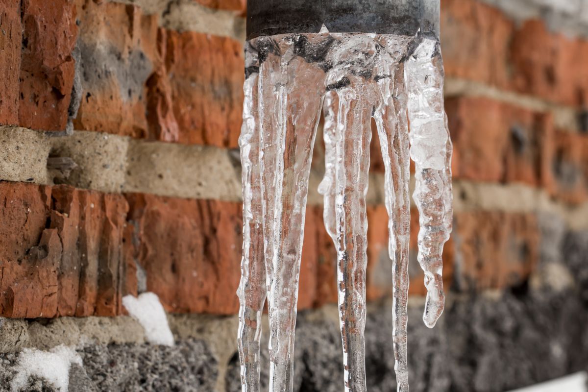 Icicles forming along a roof edge in winter